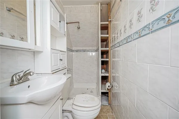 a large kitchen with stainless steel appliances kitchen island granite countertop a refrigerator and a sink