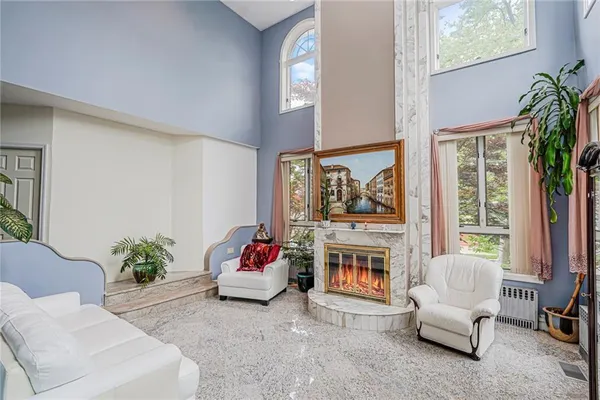 a living room with furniture and a chandelier