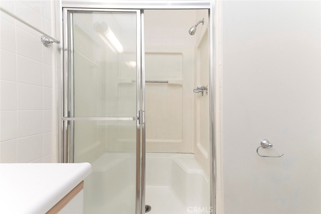 121 Sinclair Avenue, Unit 122 Glendale, CA 91206 - Photo 14 of 23 a bathroom with a shower and a glass door