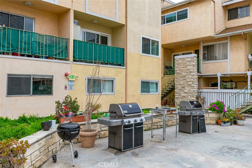 121 Sinclair Avenue, Unit 122 Glendale, CA 91206 - Photo 21 of 23 a view of a patio with chairs and potted plants