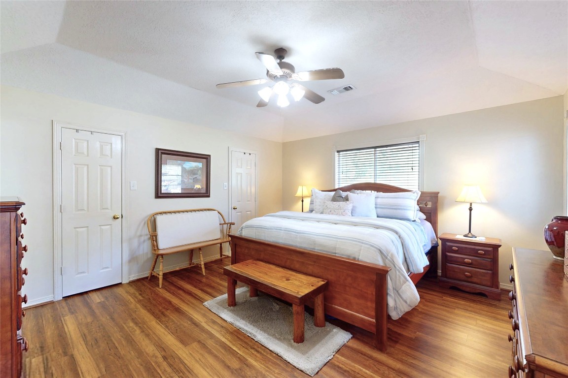 142 Sentinel Oaks Pinehurst, TX 77362 - Photo 17 of 41 a bedroom with a bed and a chandelier