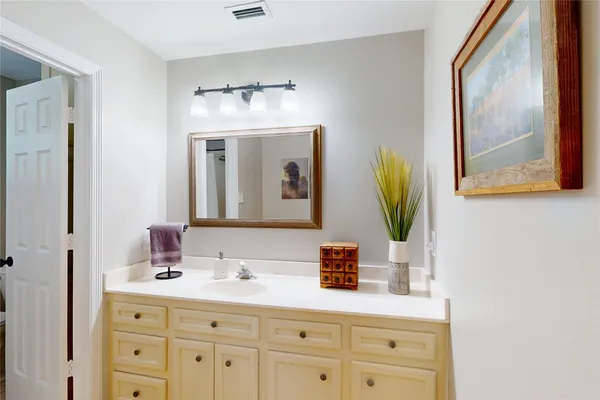 a bathroom with a sink vanity and mirror