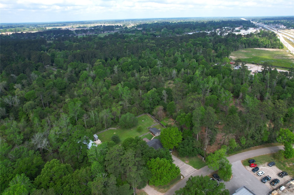142 Sentinel Oaks Pinehurst, TX 77362 - Photo 41 of 41 an aerial view of a houses with a lush green hillside