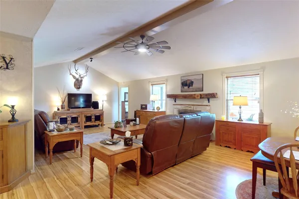 a living room with furniture a fireplace and a flat screen tv