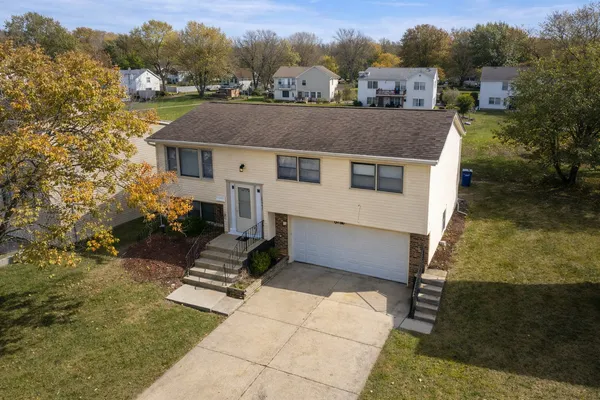 an aerial view of a house with a yard