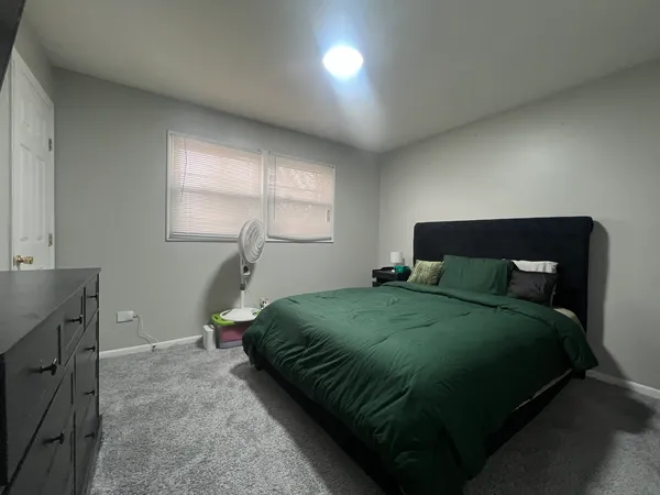 a bedroom with a bed and window