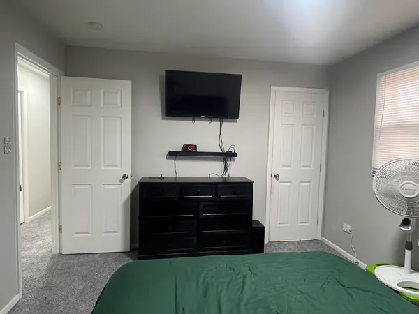 a room that has a dresser and a flat screen tv