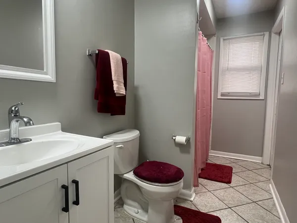 a bathroom with a sink toilet and a mirror