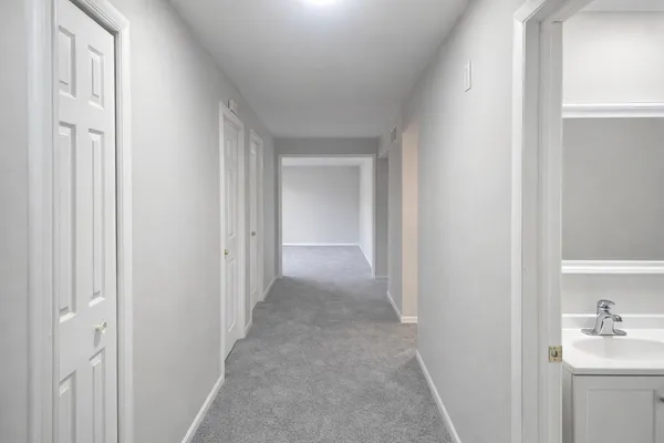 a view of a hallway with bathroom
