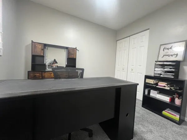 a bedroom with a bed and a tv