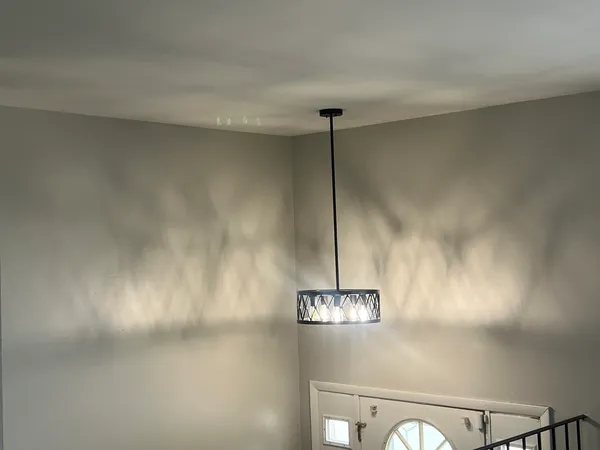 a view of a room with a chandelier fan