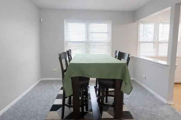 a view of a dining room with furniture and window