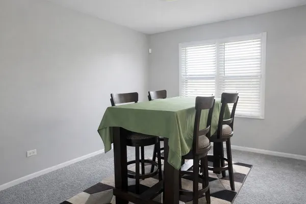 a view of a dining room with furniture and window