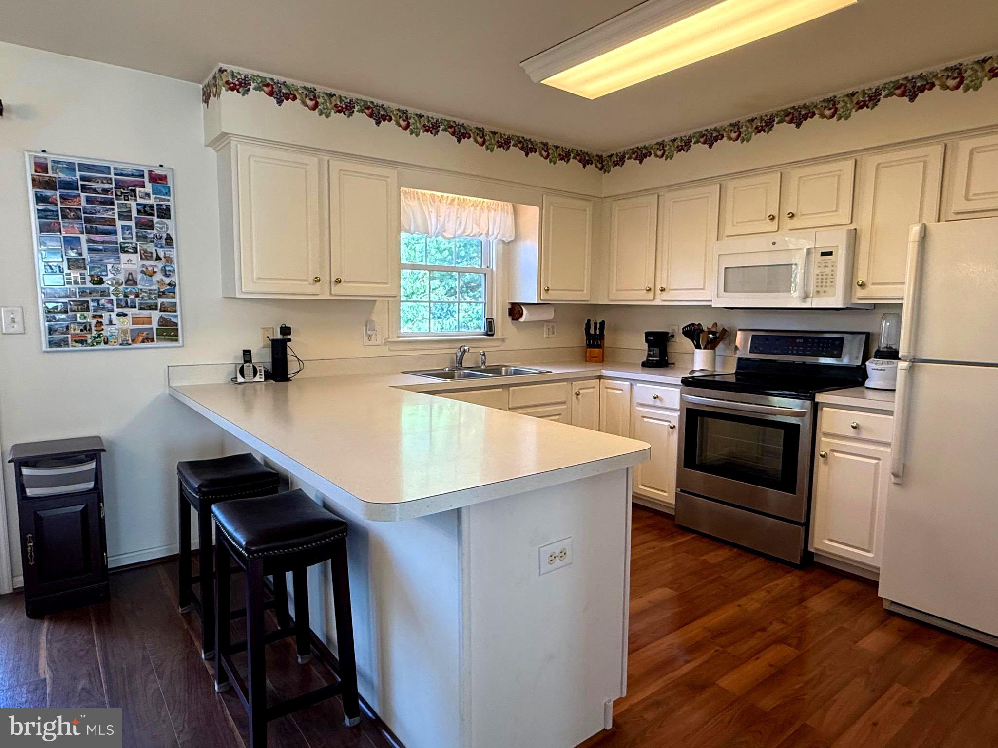 51 Finch Lane Falling Waters, WV 25419 - Photo 8 of 37 a kitchen with a sink cabinets stainless steel appliances and a window