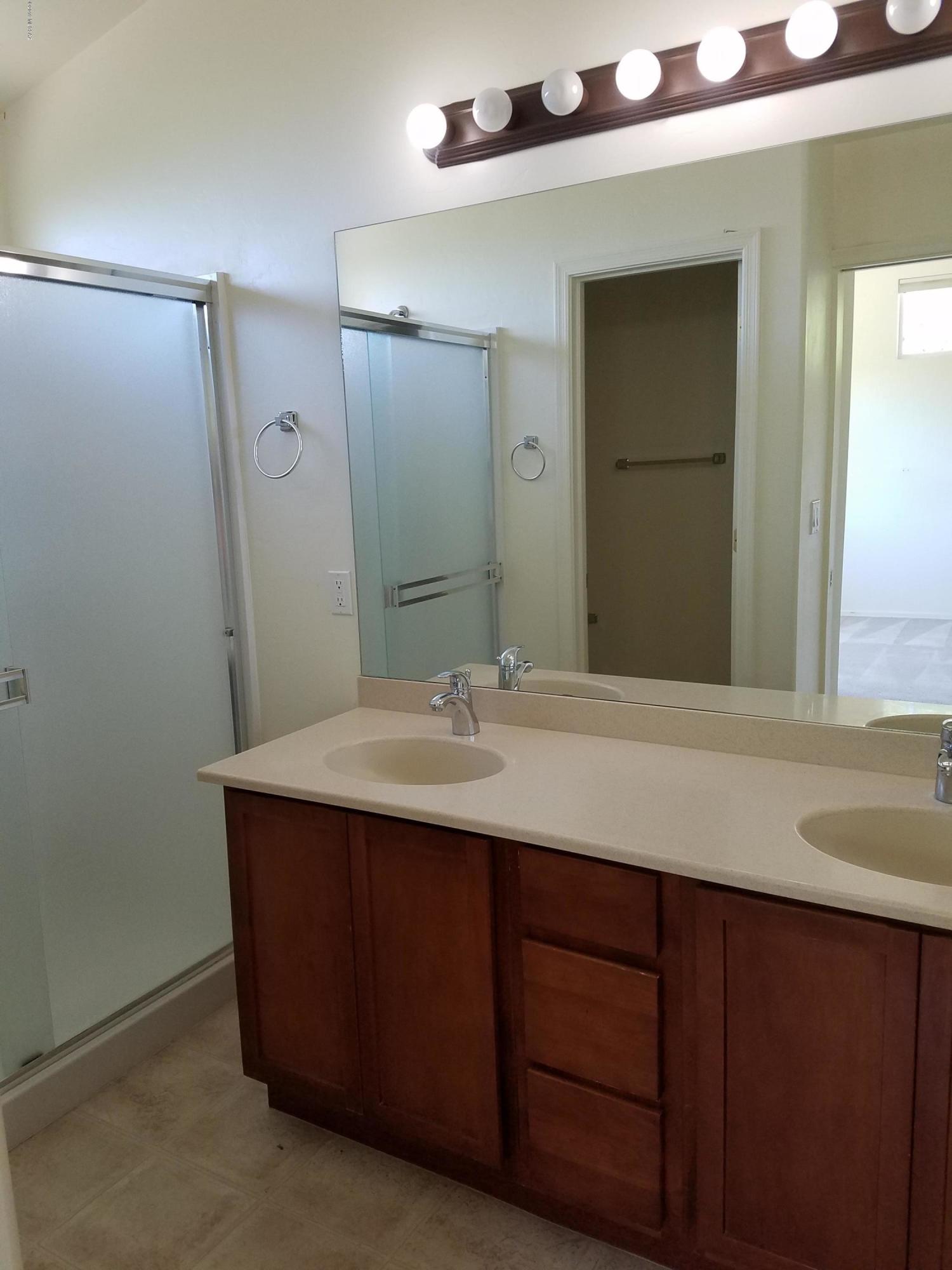 1175 Avenida Leon Rio Rico, AZ 85648 - Photo 23 of 24 a bathroom with a granite countertop sink and a mirror