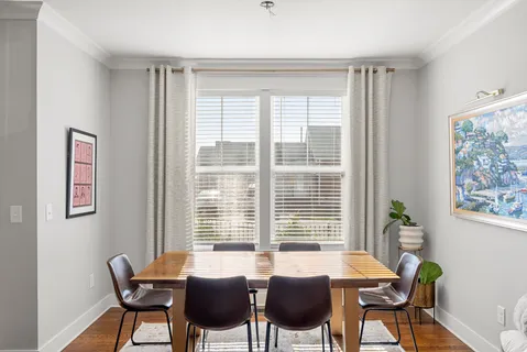 a view of a dining room with furniture and windows