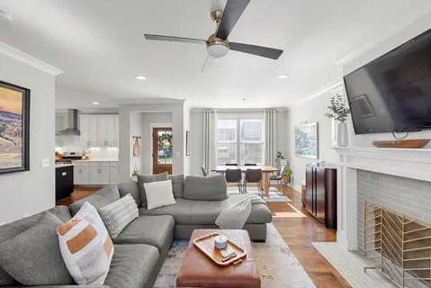 a living room with furniture a fireplace and a flat screen tv