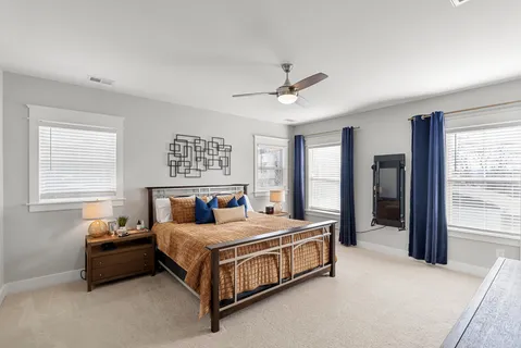 a bedroom with a bed couch and window