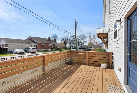 a view of balcony with wooden floor and outdoor seating