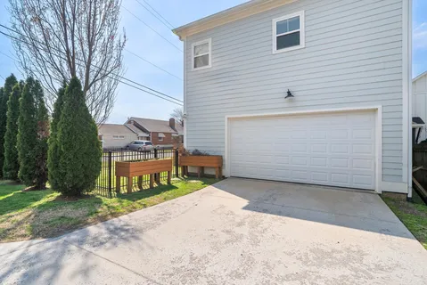 a view of a house with a yard and garage