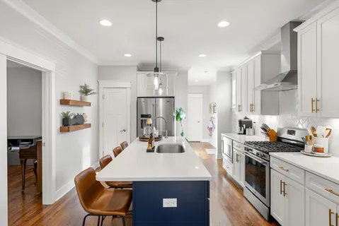 a kitchen with stainless steel appliances a refrigerator sink and stove