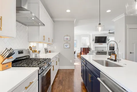 a kitchen with a sink stove and refrigerator