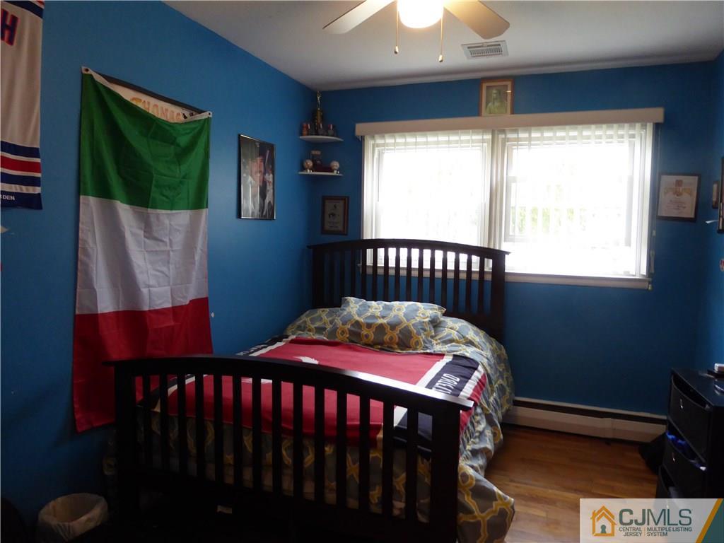 102 Stony Road Edison, NJ 08817 - Photo 11 of 21 a bedroom with a bed a window and dresser