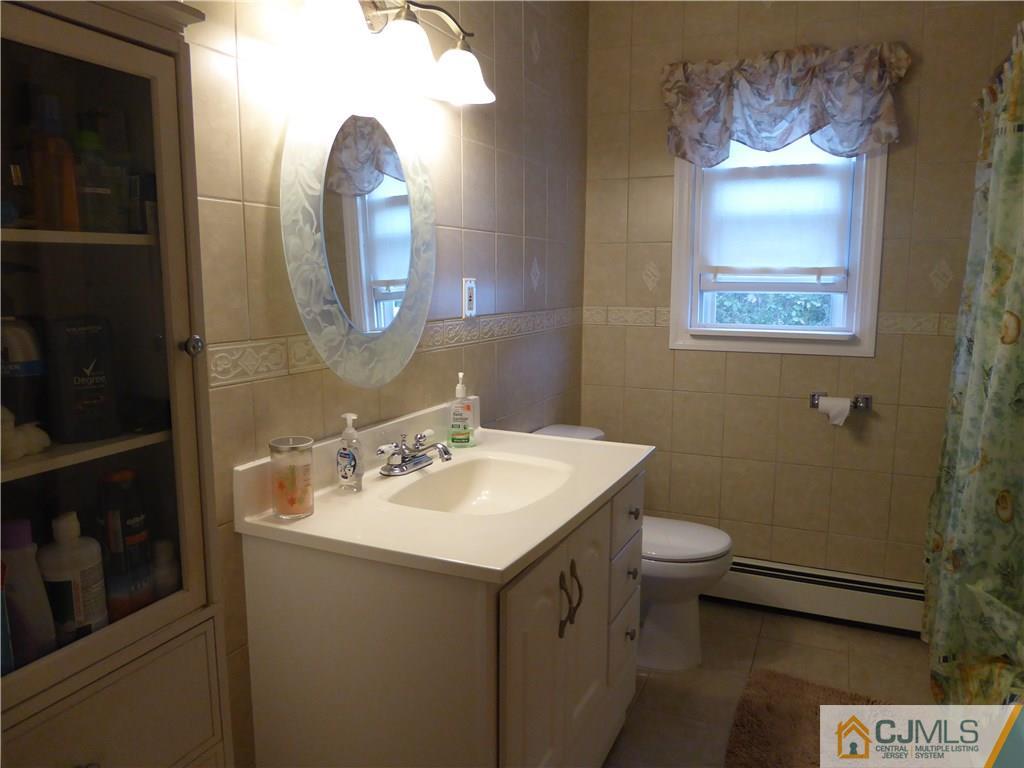 102 Stony Road Edison, NJ 08817 - Photo 13 of 21 a bathroom with a sink and a mirror
