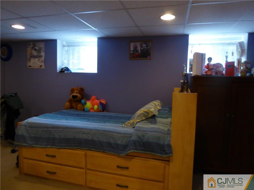 102 Stony Road Edison, NJ 08817 - Photo 15 of 21 a room with furniture and a mirror