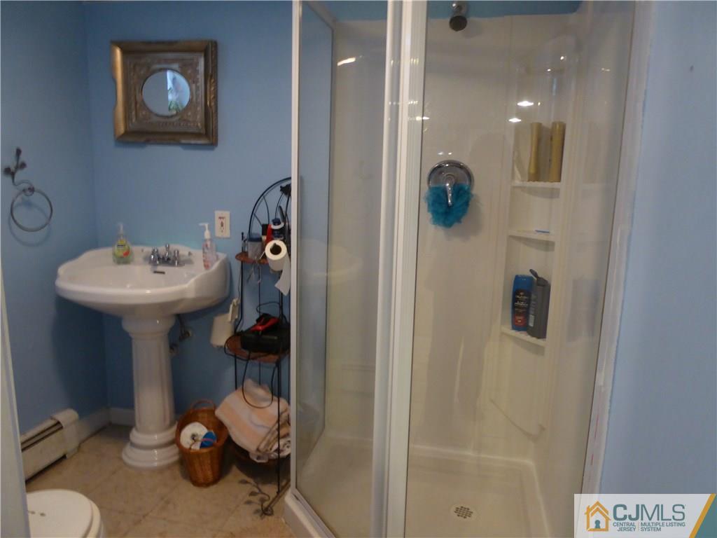 102 Stony Road Edison, NJ 08817 - Photo 16 of 21 a bathroom with a sink mirror and toilet