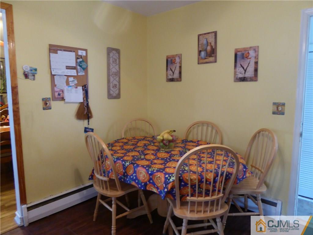 102 Stony Road Edison, NJ 08817 - Photo 8 of 21 a dining room with furniture and wooden floor