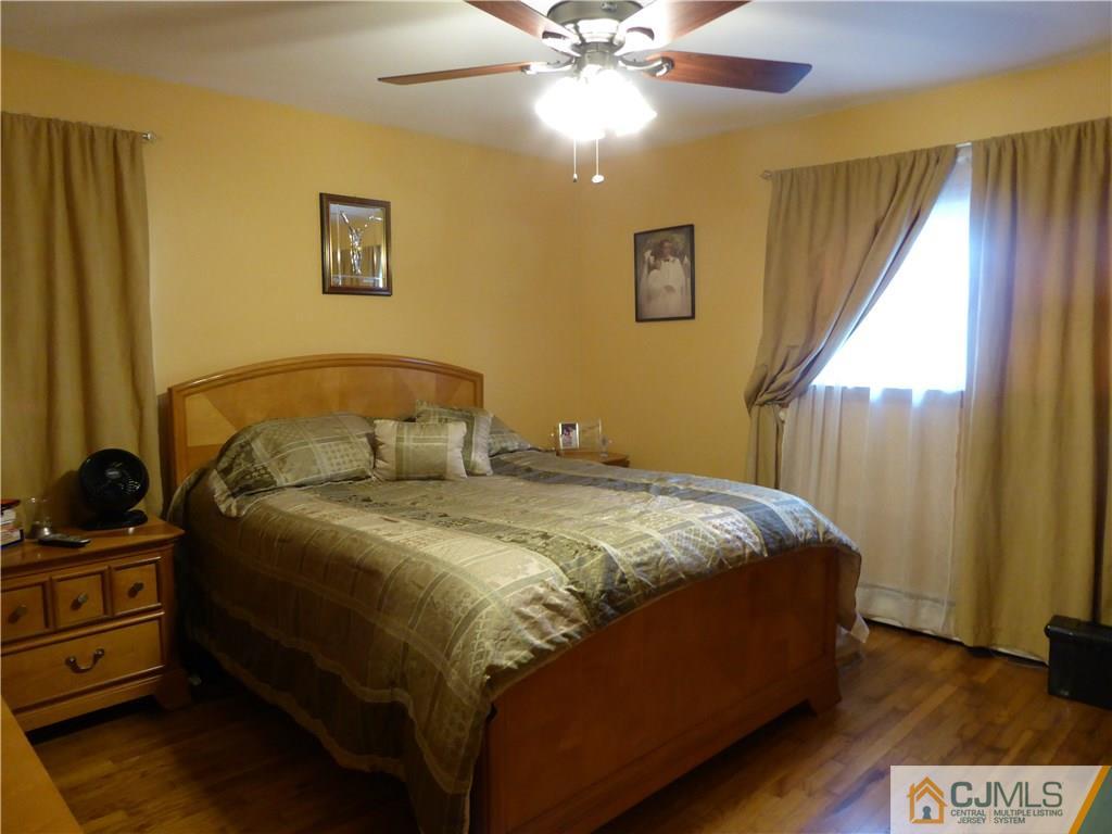 102 Stony Road Edison, NJ 08817 - Photo 10 of 21 a bedroom with a bed and a chandelier
