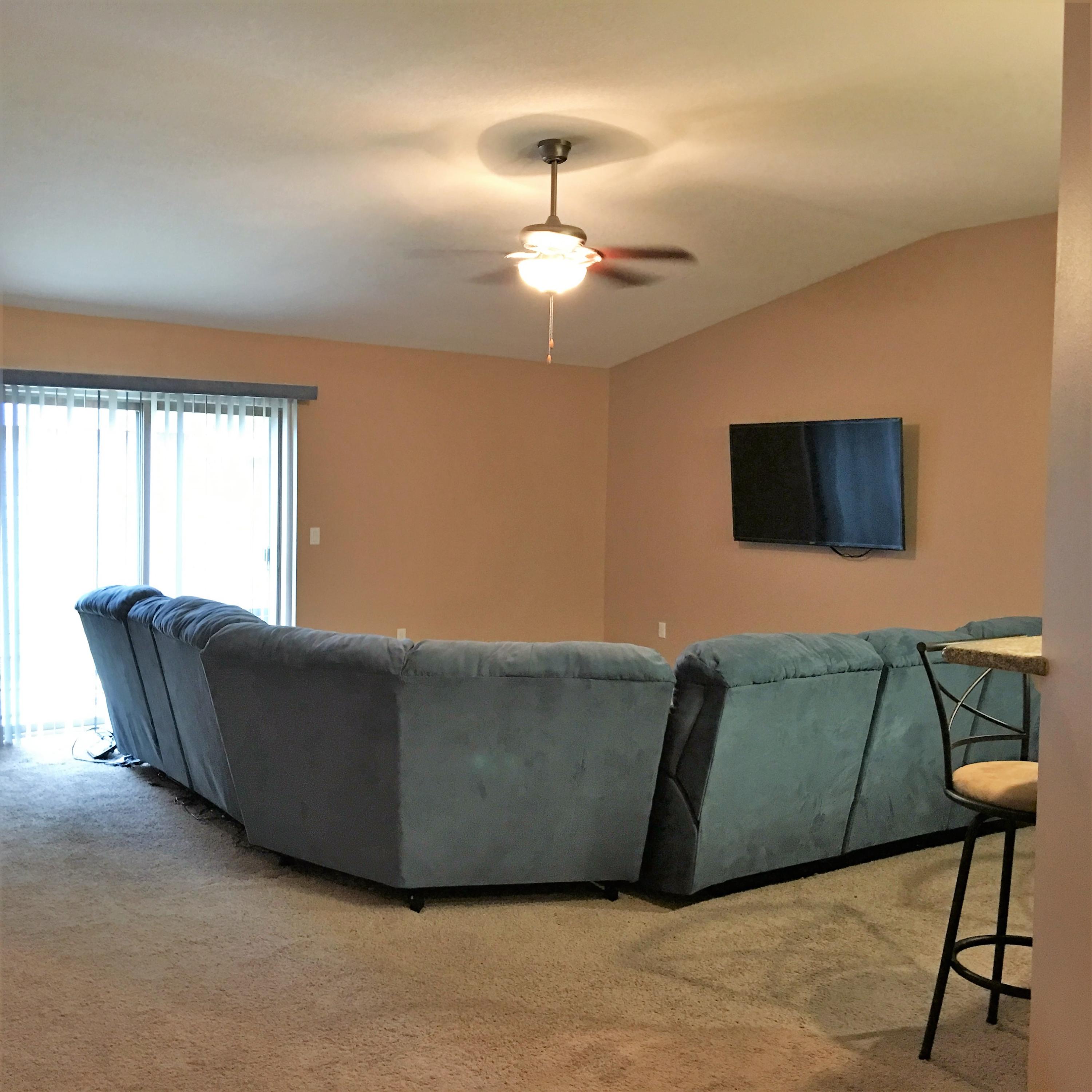 4519 Hermosa Road Crestview, FL 32539 - Photo 14 of 34 a living room with furniture and a flat screen tv