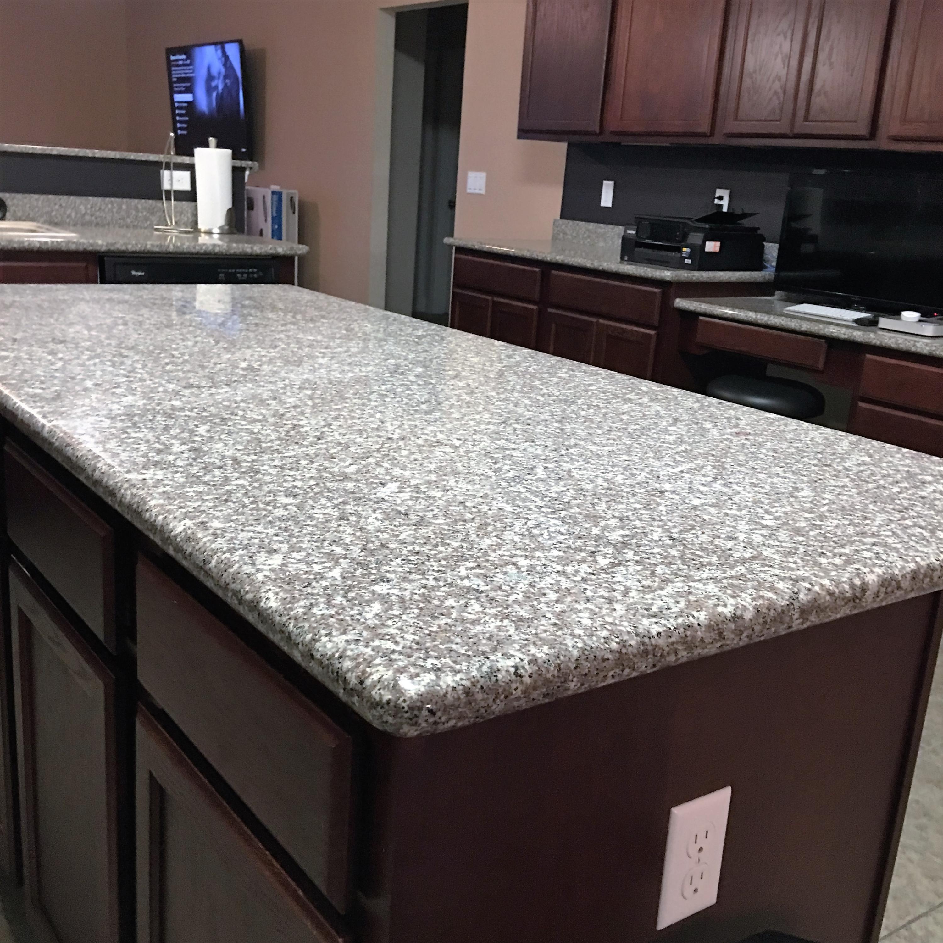 4519 Hermosa Road Crestview, FL 32539 - Photo 5 of 34 a kitchen with kitchen island granite countertop a sink a counter top space and cabinets
