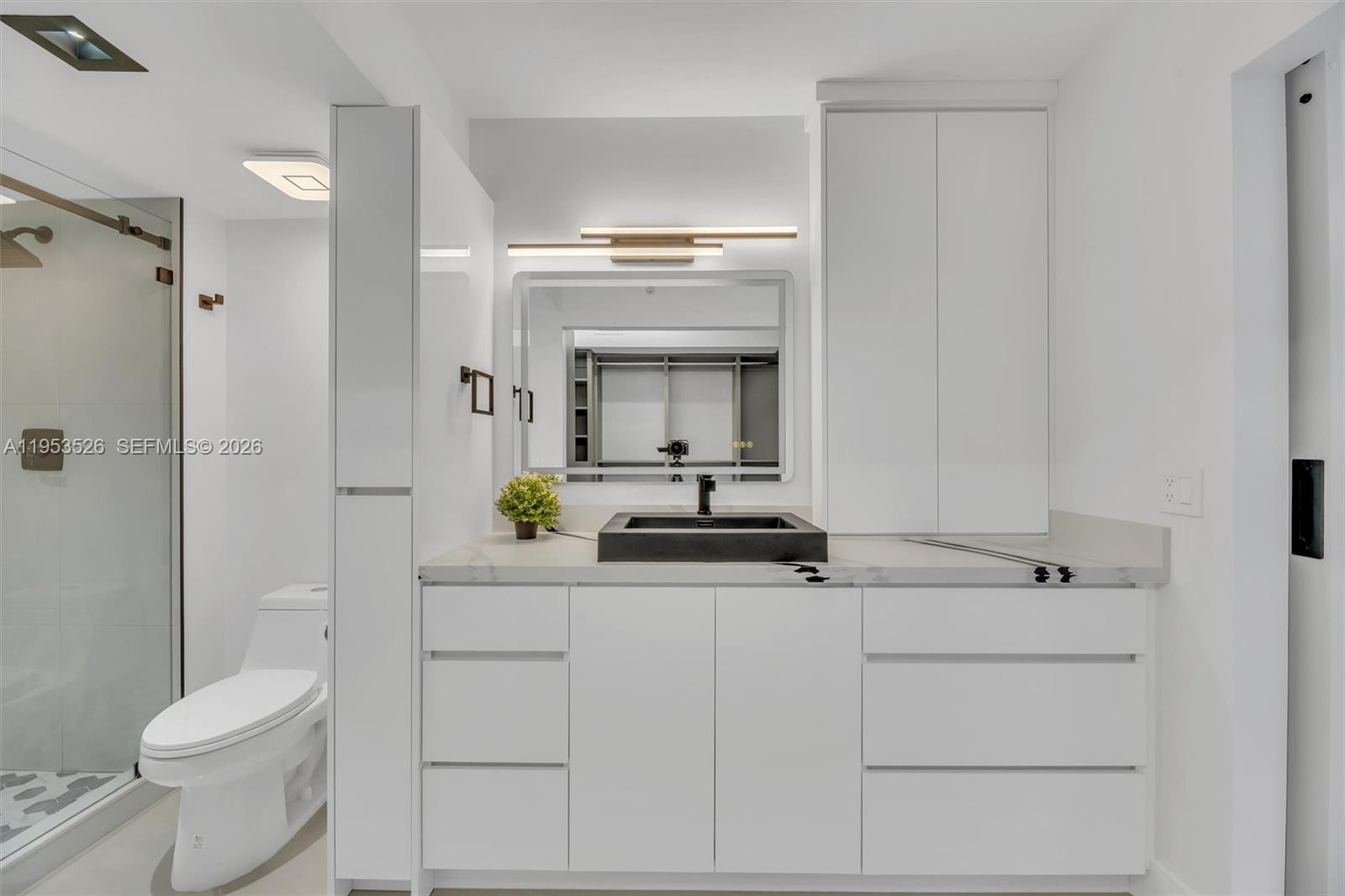 2601 North Nob Hill Road, Unit 407 Sunrise, FL 33322 - Photo 17 of 38 a bathroom with a sink a toilet and shower