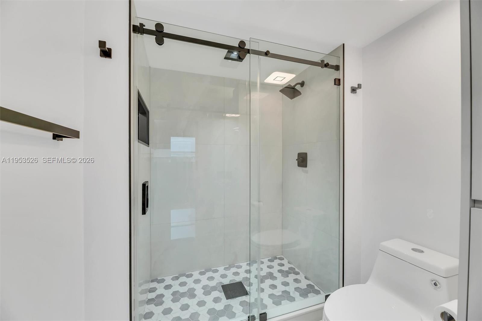 2601 North Nob Hill Road, Unit 407 Sunrise, FL 33322 - Photo 19 of 38 a bathroom with a toilet and shower