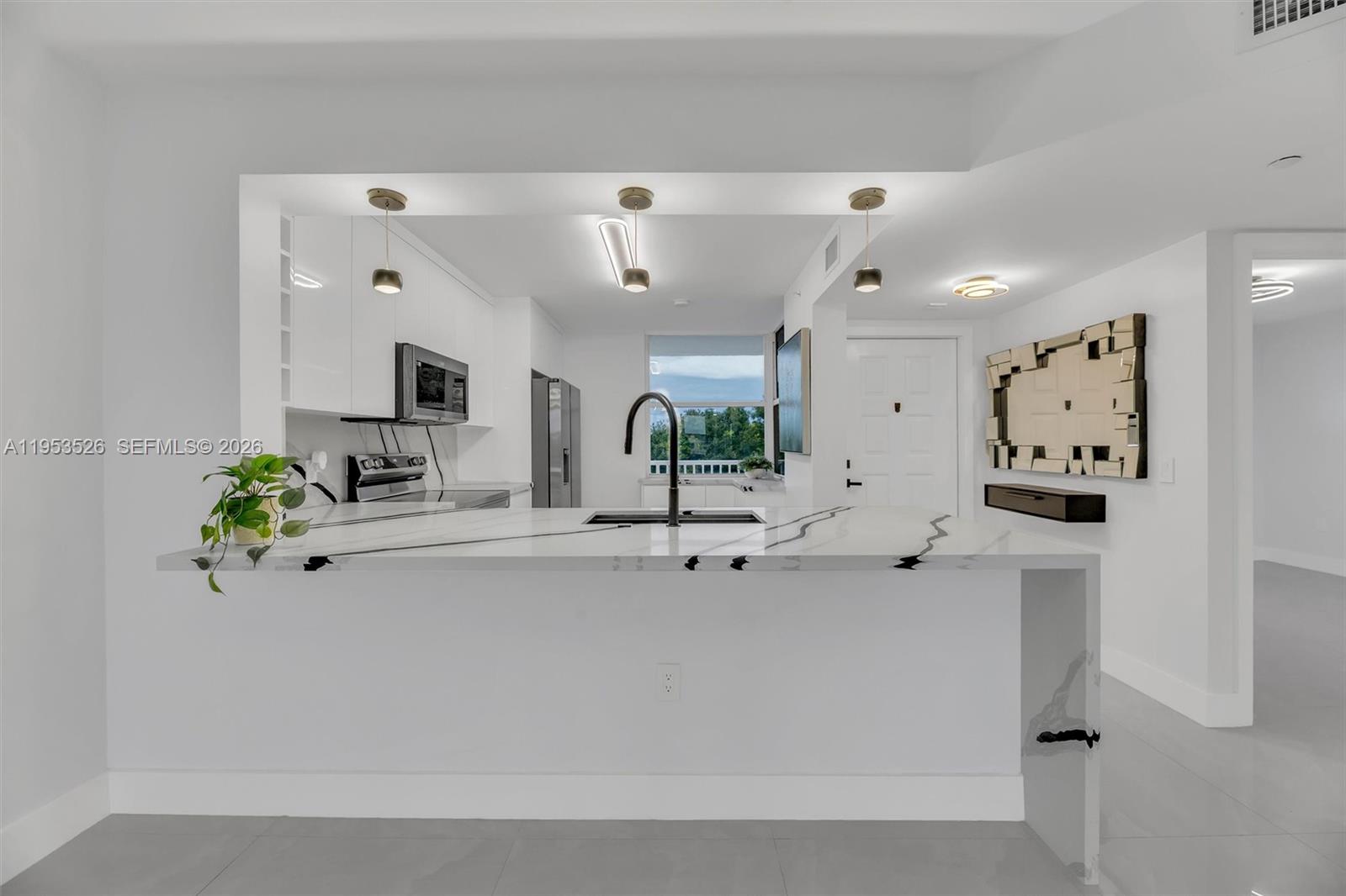 2601 North Nob Hill Road, Unit 407 Sunrise, FL 33322 - Photo 2 of 38 a view of living room with furniture and potted plants