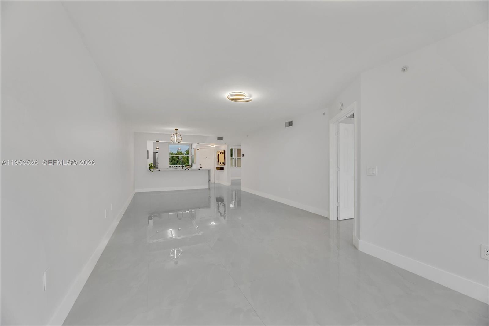 2601 North Nob Hill Road, Unit 407 Sunrise, FL 33322 - Photo 23 of 38 a view of empty room with wooden floor