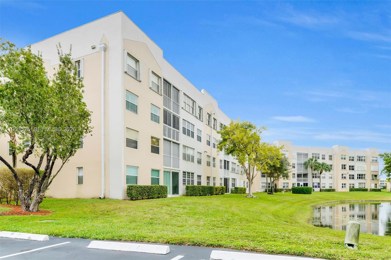 2601 North Nob Hill Road, Unit 407 Sunrise, FL 33322 - Photo 31 of 38 a view of a building with a yard