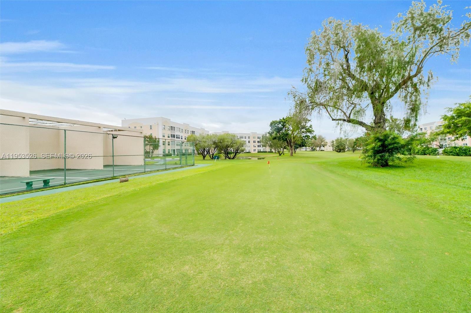 2601 North Nob Hill Road, Unit 407 Sunrise, FL 33322 - Photo 32 of 38 a view of a big yard with a large trees