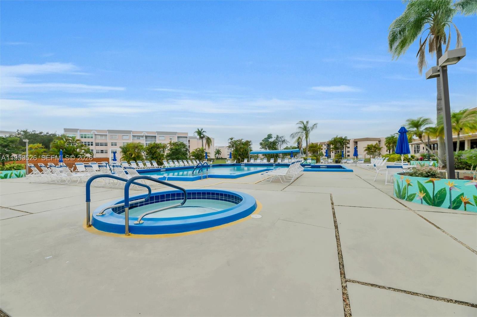 2601 North Nob Hill Road, Unit 407 Sunrise, FL 33322 - Photo 33 of 38 a view of a swimming pool with a patio and a garden