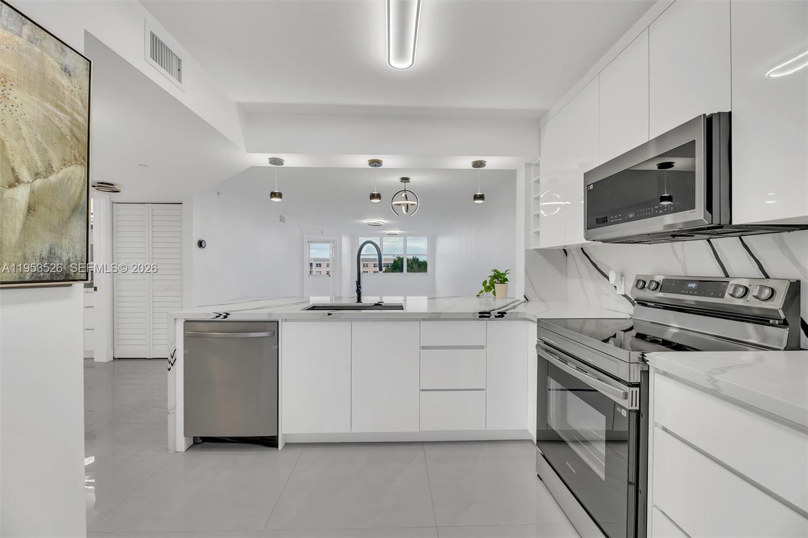 2601 North Nob Hill Road, Unit 407 Sunrise, FL 33322 - Photo 5 of 38 a kitchen with stainless steel appliances a sink stove and cabinets