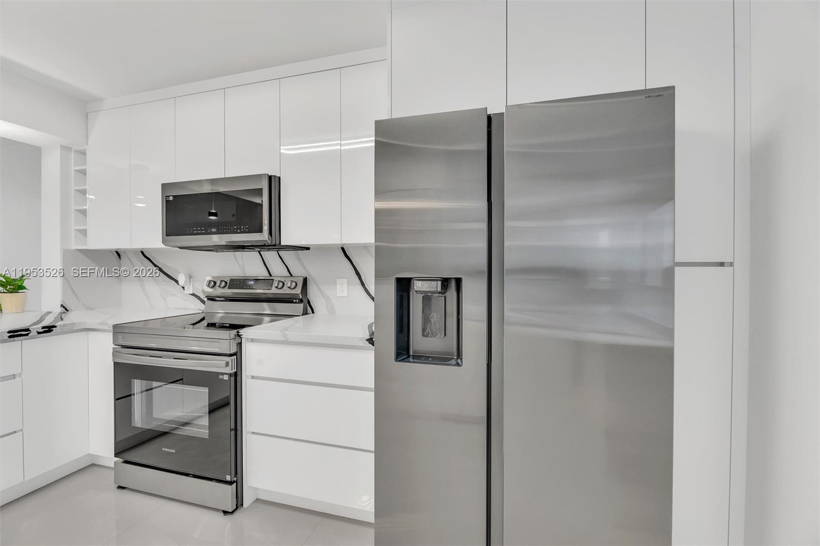 2601 North Nob Hill Road, Unit 407 Sunrise, FL 33322 - Photo 6 of 38 a kitchen with a refrigerator and a stove top oven