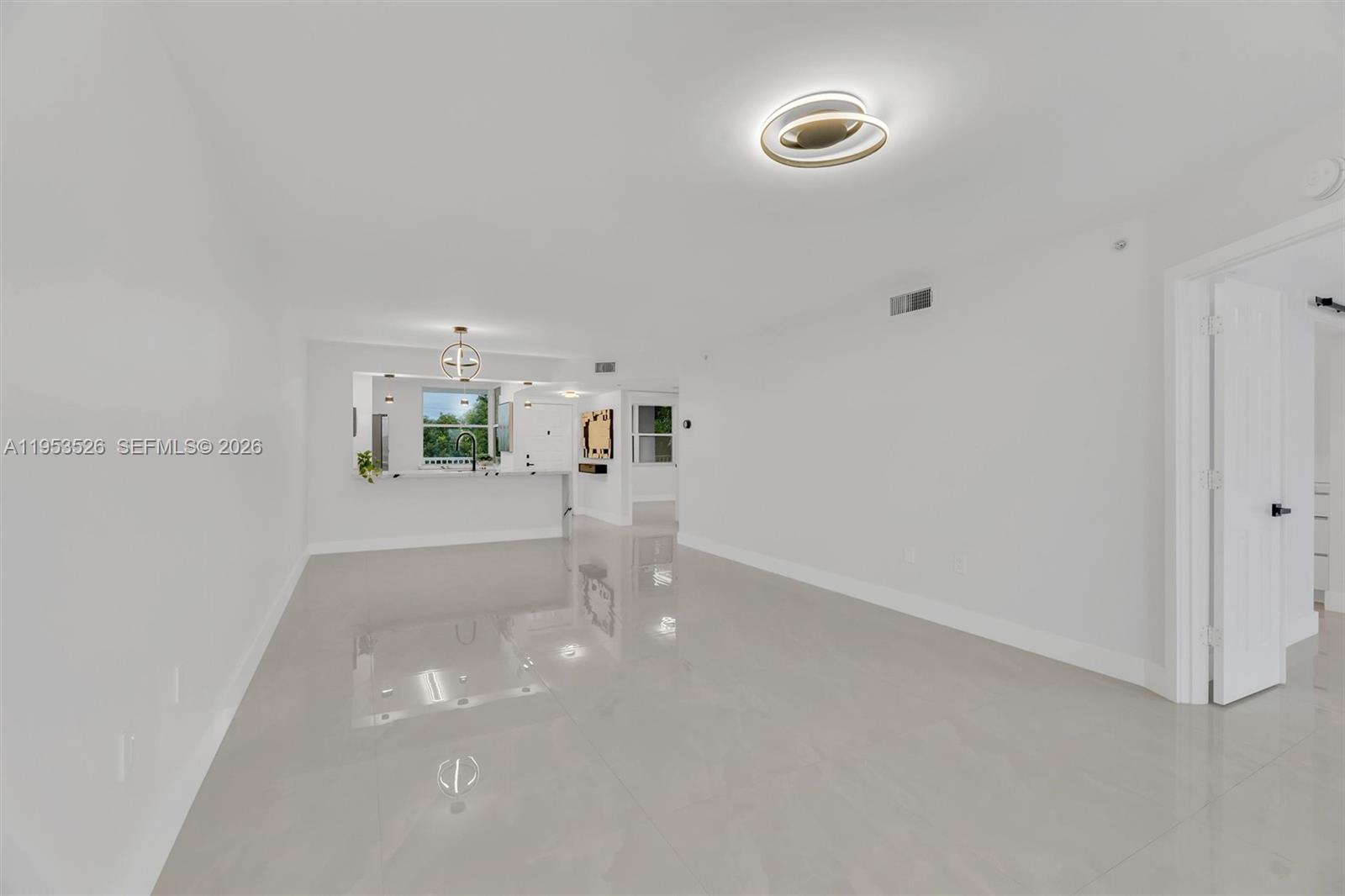 2601 North Nob Hill Road, Unit 407 Sunrise, FL 33322 - Photo 7 of 38 a view of a room with furniture and wooden floor