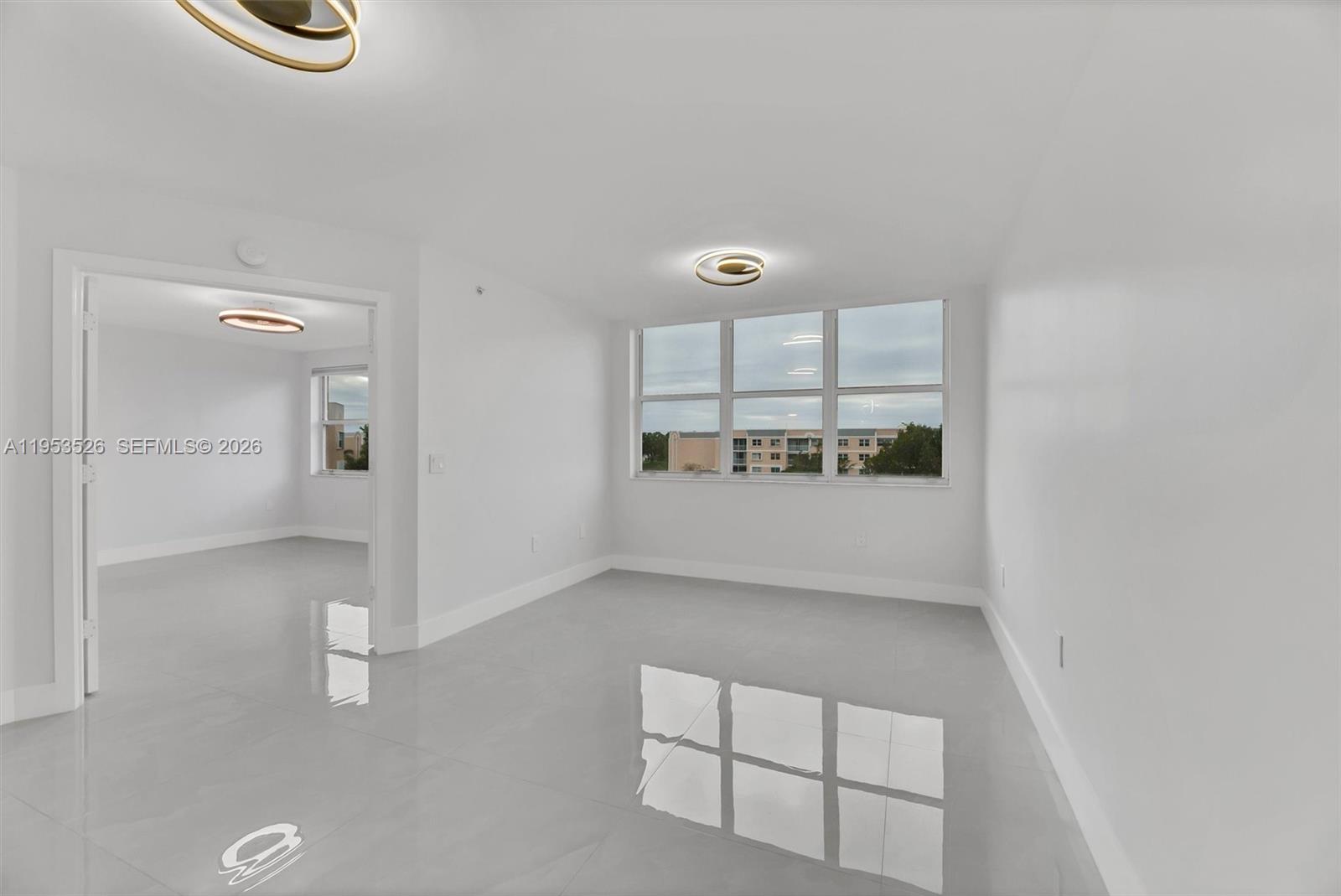 2601 North Nob Hill Road, Unit 407 Sunrise, FL 33322 - Photo 9 of 38 wooden floor in an empty room