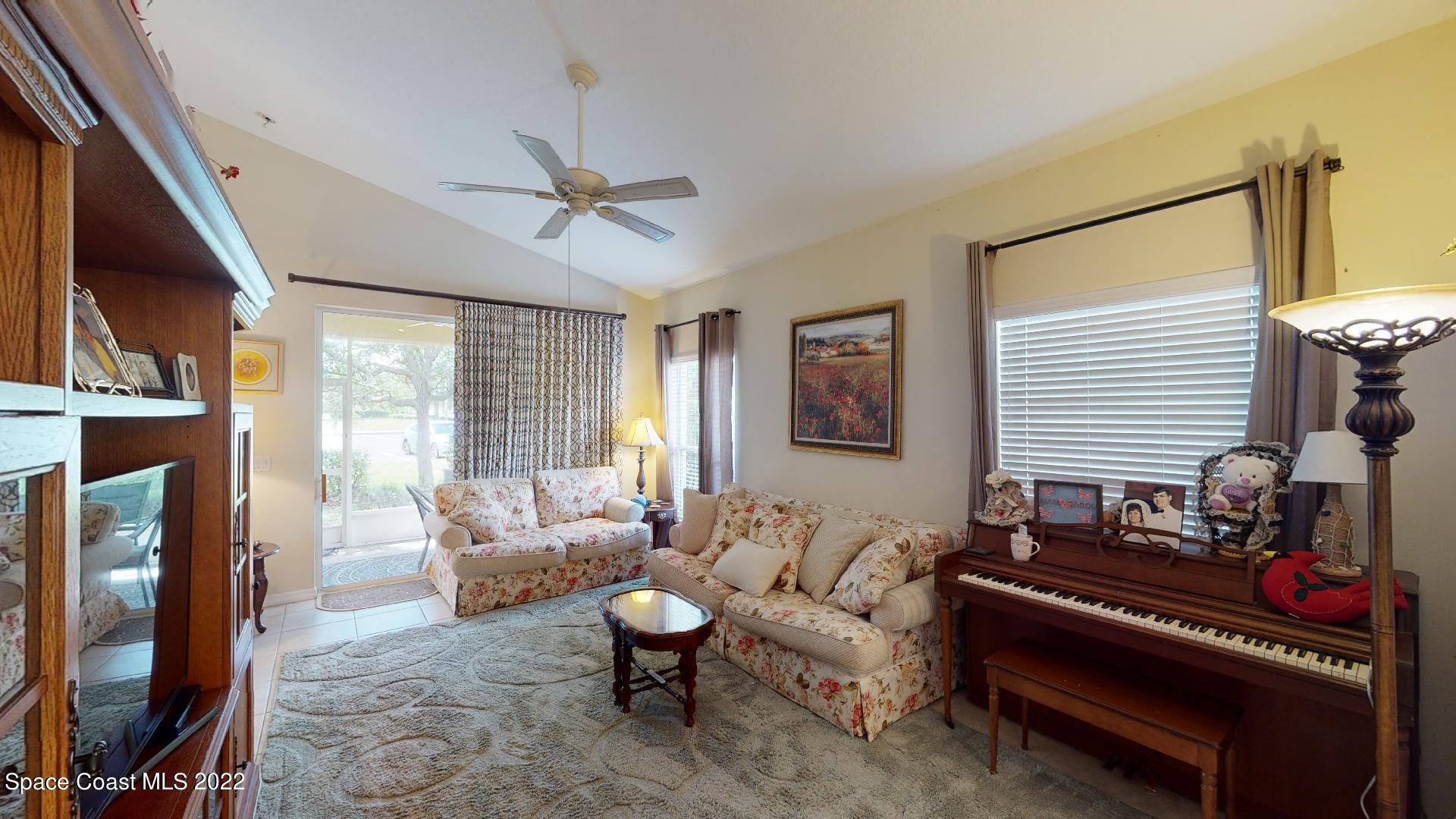 3151 Le Conte Street Melbourne, FL 32940 - Photo 13 of 30 a living room with furniture a fireplace and a flat screen tv