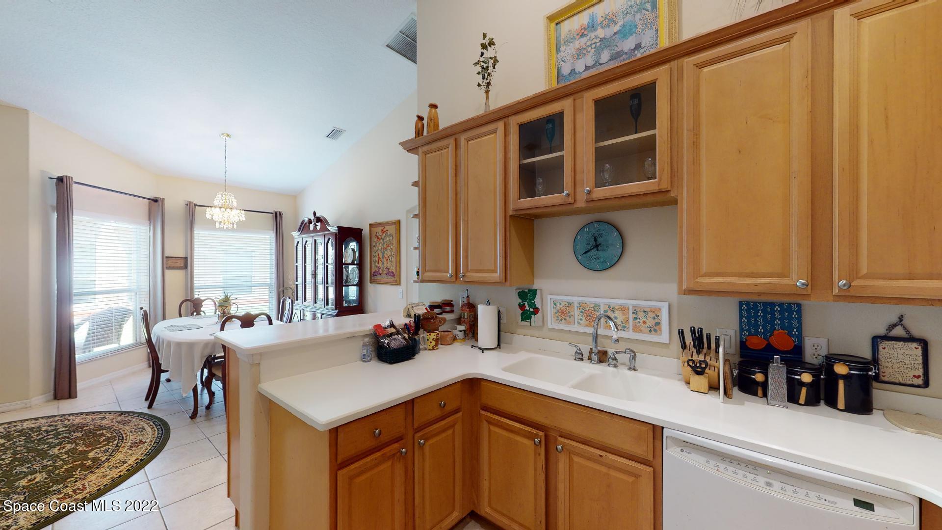 3151 Le Conte Street Melbourne, FL 32940 - Photo 19 of 30 a kitchen with stainless steel appliances a sink a stove and a refrigerator