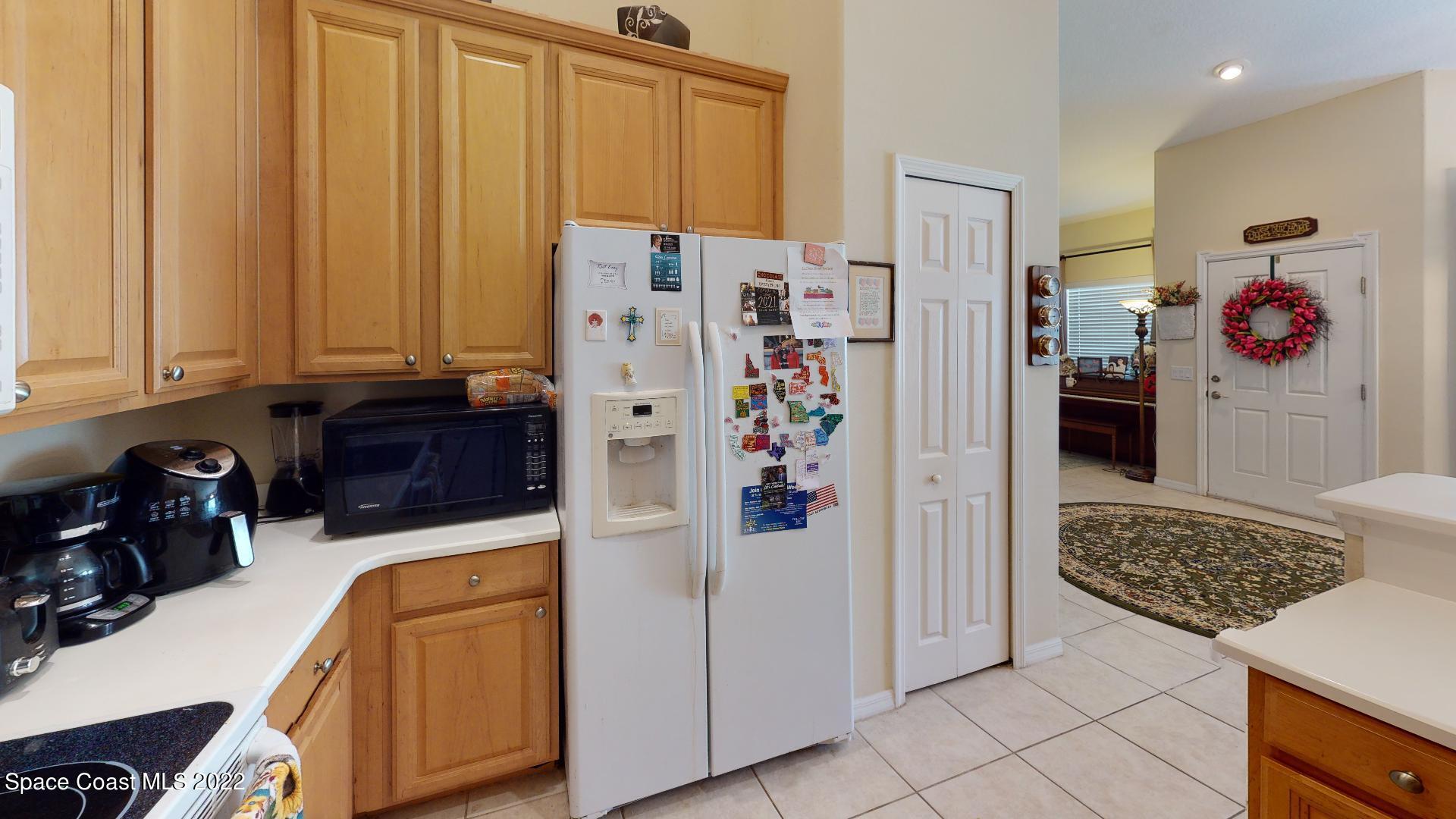 3151 Le Conte Street Melbourne, FL 32940 - Photo 20 of 30 a kitchen with stainless steel appliances granite countertop a refrigerator and a stove