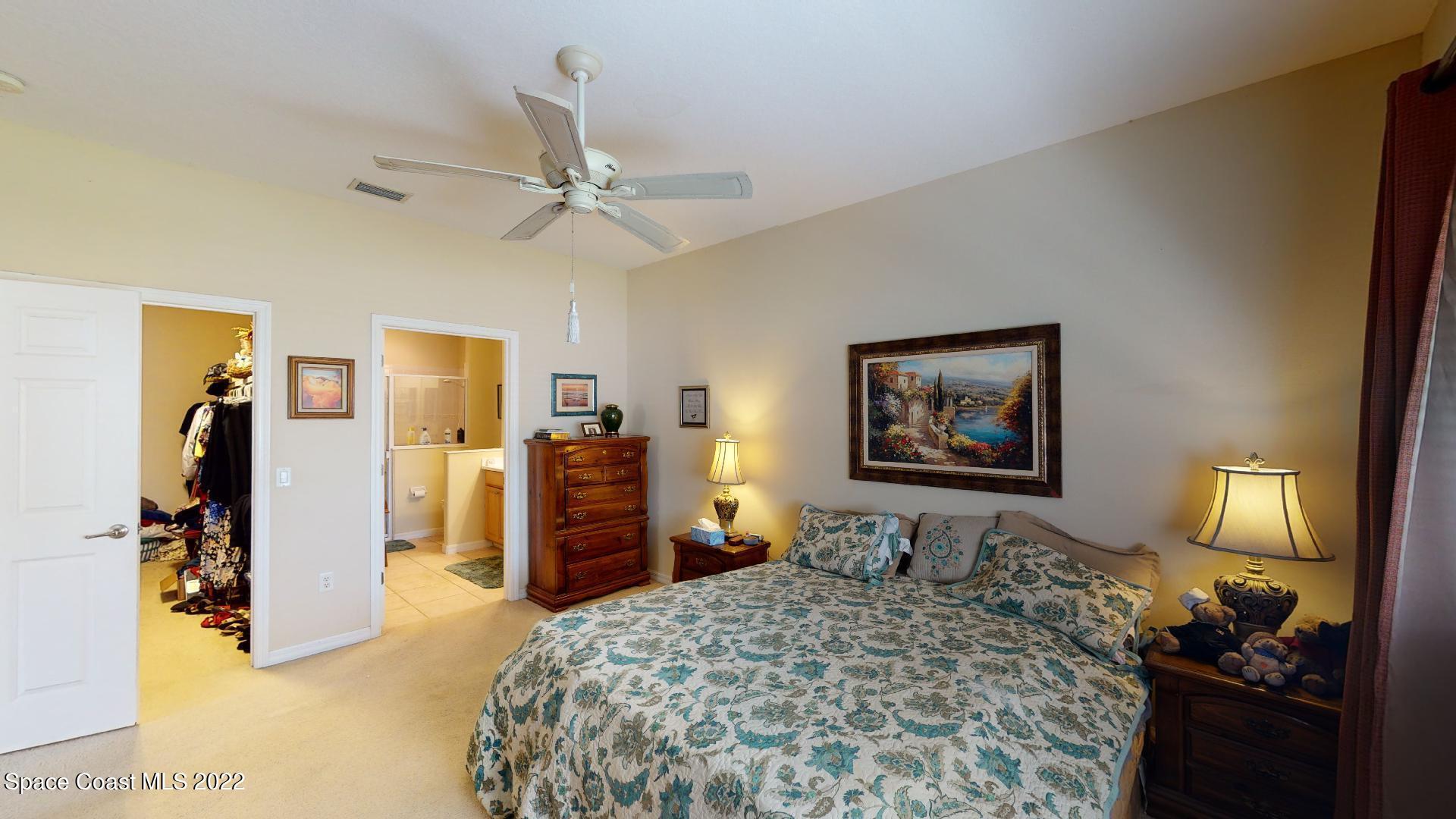 3151 Le Conte Street Melbourne, FL 32940 - Photo 22 of 30 a bedroom with a bed and a dresser