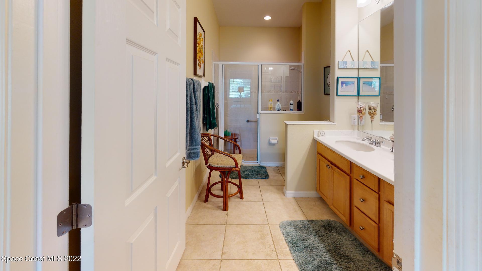 3151 Le Conte Street Melbourne, FL 32940 - Photo 23 of 30 a bathroom with a sink vanity and a mirror